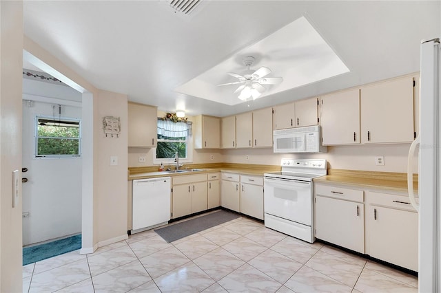 kitchen with cream cabinets, white appliances, ceiling fan, and sink