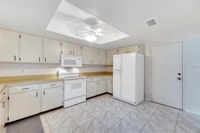 kitchen with ceiling fan, a raised ceiling, and white appliances