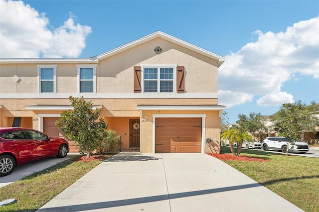 view of front of home featuring a garage and a front yard