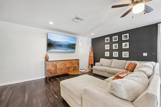 living room featuring wood-type flooring, a textured ceiling, and ceiling fan