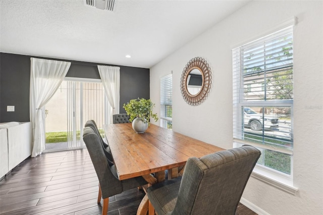 dining space with plenty of natural light and hardwood / wood-style floors