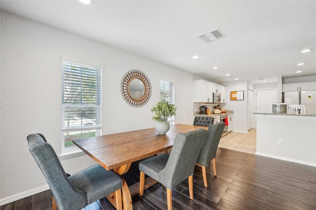 dining room featuring a healthy amount of sunlight and light hardwood / wood-style floors