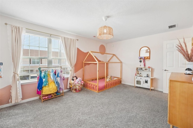 carpeted bedroom with a textured ceiling