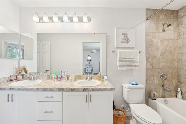 full bathroom with vanity, toilet, and tiled shower / bath