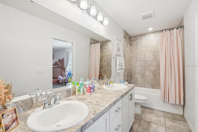 full bathroom featuring tile patterned flooring, vanity, toilet, and shower / tub combo