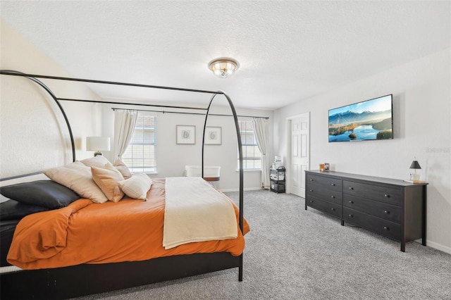 carpeted bedroom featuring a textured ceiling