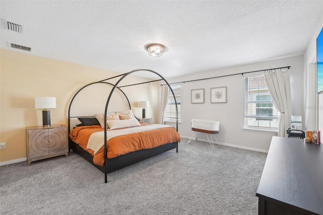 carpeted bedroom featuring a textured ceiling