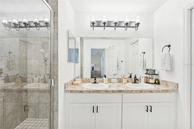 bathroom with vanity and a shower with shower door