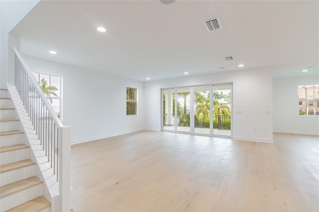 spare room with light hardwood / wood-style flooring and a healthy amount of sunlight