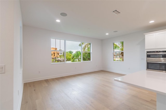 unfurnished living room with light hardwood / wood-style flooring