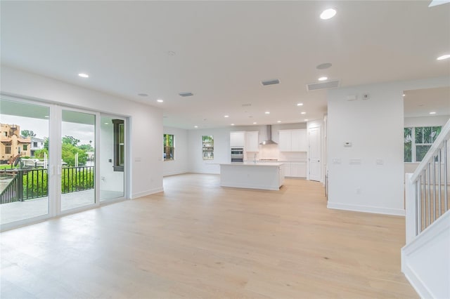 unfurnished living room with light wood-type flooring