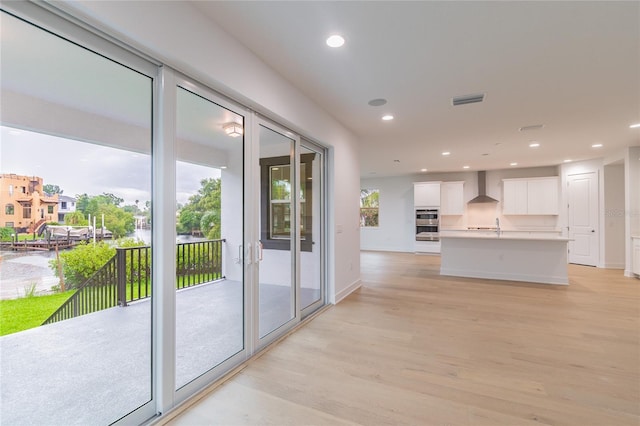 doorway to outside featuring light wood-type flooring