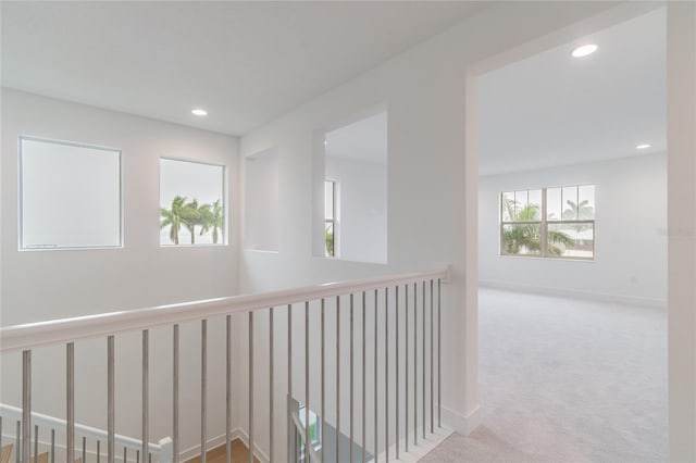 hallway with light colored carpet