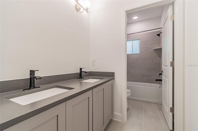 full bathroom featuring tile patterned flooring, vanity, toilet, and tiled shower / bath