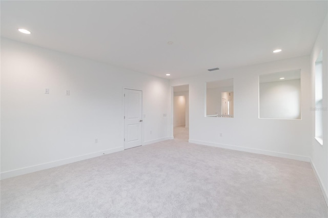 spare room featuring light colored carpet