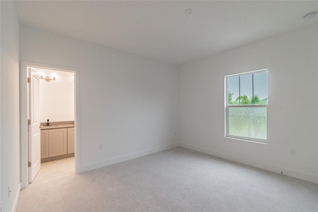 unfurnished room with light carpet