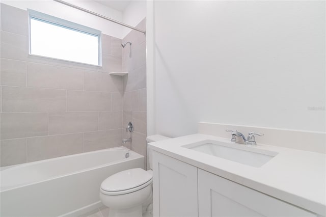 full bathroom featuring vanity, tiled shower / bath combo, and toilet