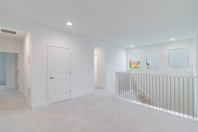 corridor with light colored carpet