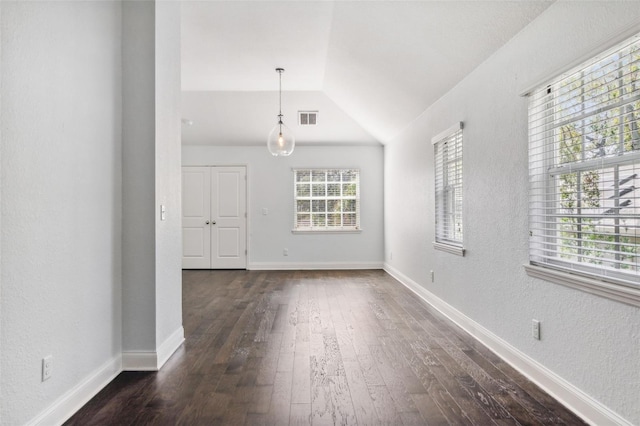 unfurnished room featuring lofted ceiling and dark hardwood / wood-style floors