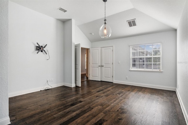 unfurnished room with lofted ceiling and dark hardwood / wood-style floors