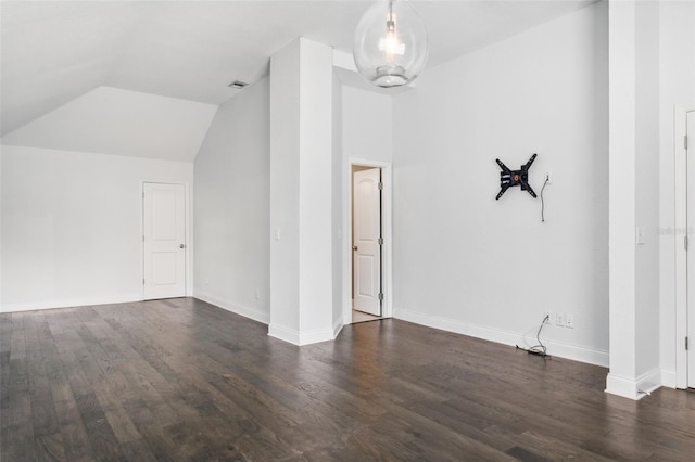 interior space with vaulted ceiling and dark hardwood / wood-style floors