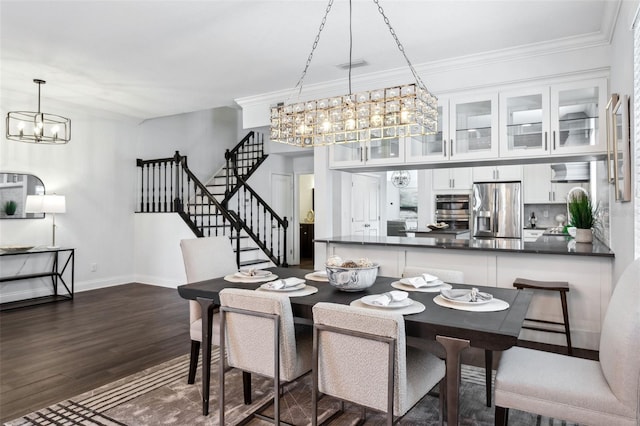 dining space featuring ornamental molding, a chandelier, and dark hardwood / wood-style flooring