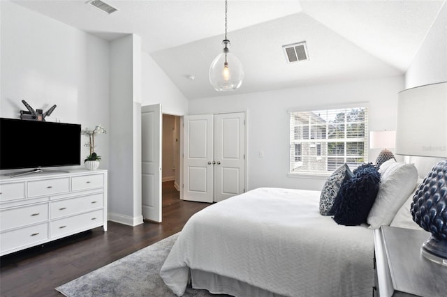 bedroom with lofted ceiling and dark hardwood / wood-style floors