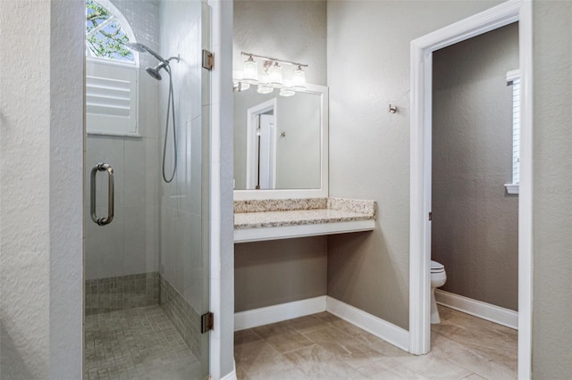 bathroom with walk in shower, vanity, and toilet