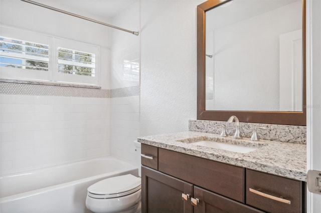 full bathroom featuring tiled shower / bath combo, vanity, and toilet