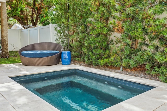 view of swimming pool with an outdoor hot tub