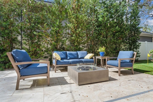 view of patio featuring an outdoor living space with a fire pit