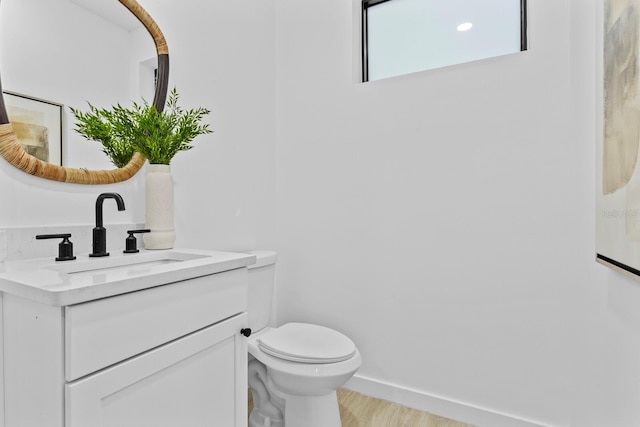 bathroom featuring hardwood / wood-style floors, vanity, and toilet