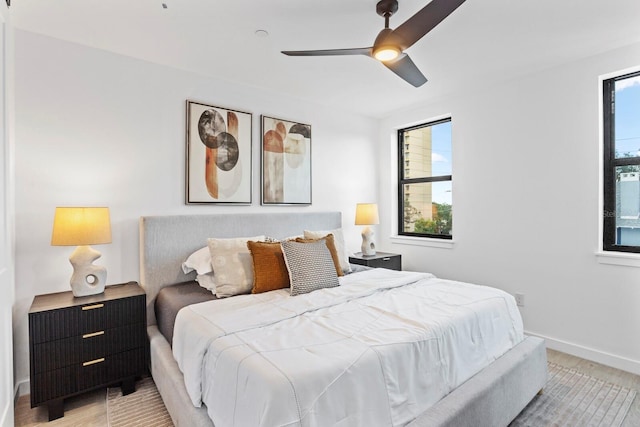 bedroom featuring multiple windows and ceiling fan