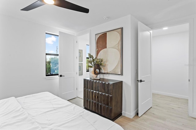 bedroom with ceiling fan and light wood-type flooring