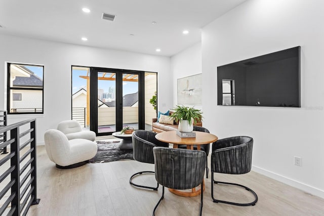 dining space with light hardwood / wood-style floors