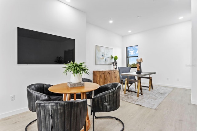 dining space with light hardwood / wood-style flooring