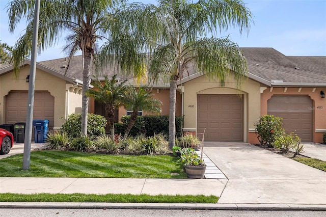 ranch-style home featuring a garage and a front yard