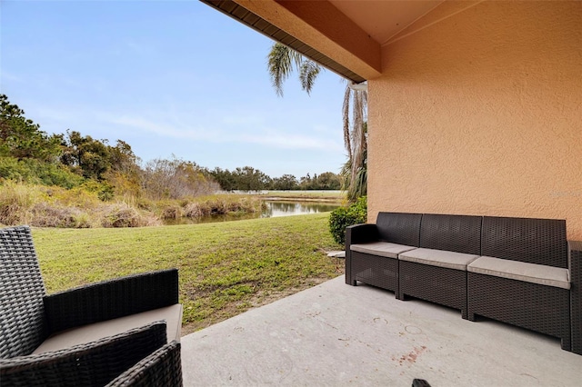 view of yard with a patio area, a water view, and an outdoor hangout area