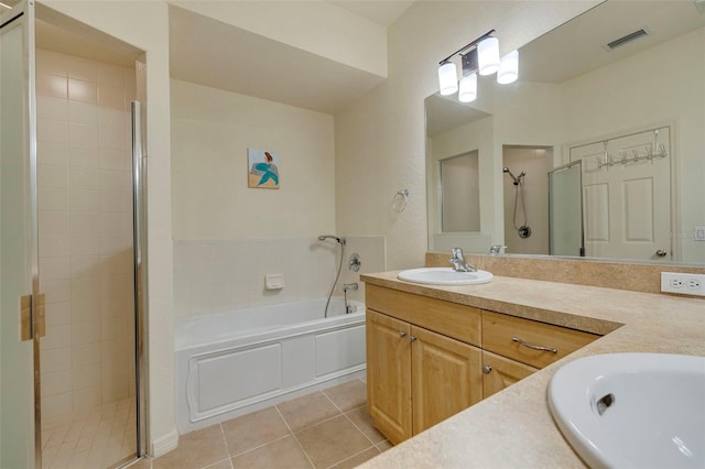 bathroom featuring plus walk in shower, tile patterned flooring, and vanity