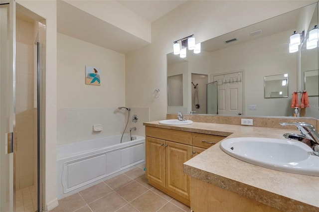 bathroom with tile patterned flooring, vanity, and independent shower and bath