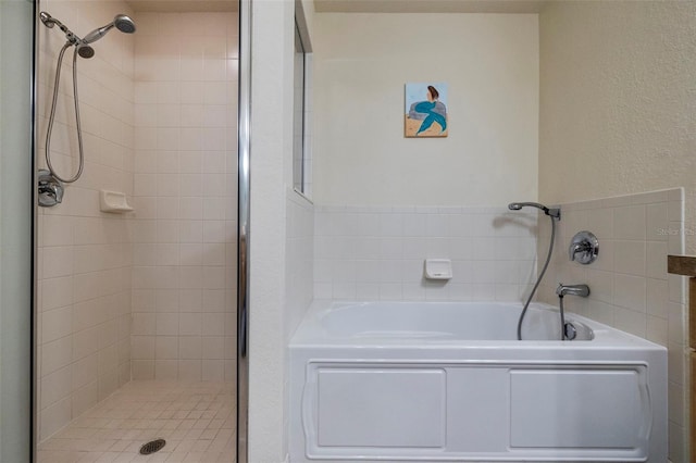 bathroom featuring shower with separate bathtub