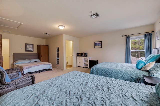 bedroom with light carpet and ensuite bath