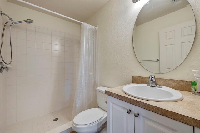 bathroom with vanity, toilet, and walk in shower