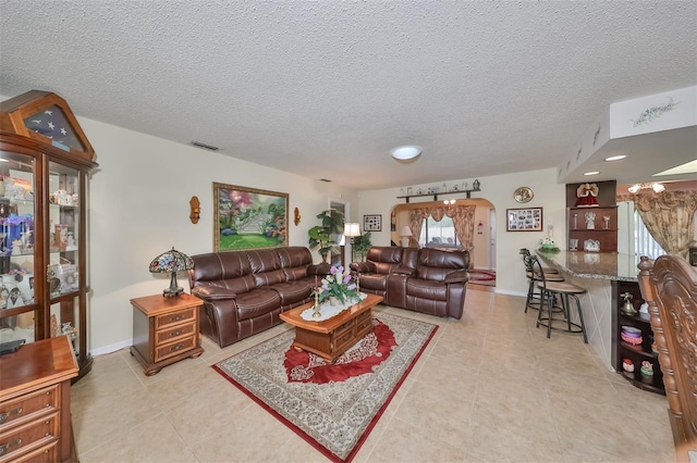 tiled living room with a textured ceiling