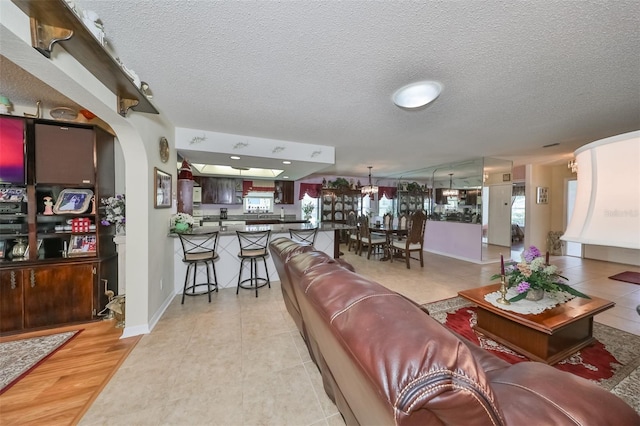 living room with light hardwood / wood-style floors and a textured ceiling