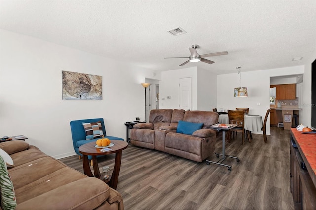 living room with visible vents, ceiling fan, a textured ceiling, and wood finished floors