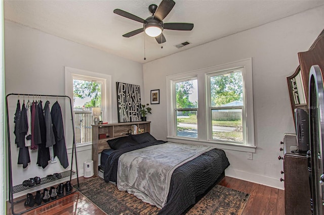 bedroom with ceiling fan and dark wood-type flooring