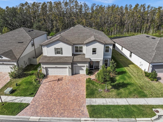 view of front facade with a garage and a front yard