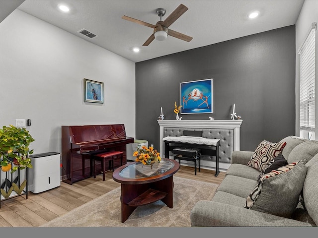 living room with ceiling fan and light hardwood / wood-style floors