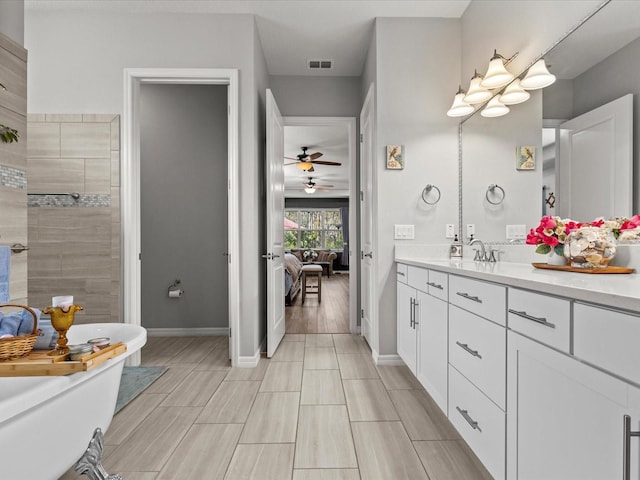 bathroom with vanity, ceiling fan, and a bathing tub